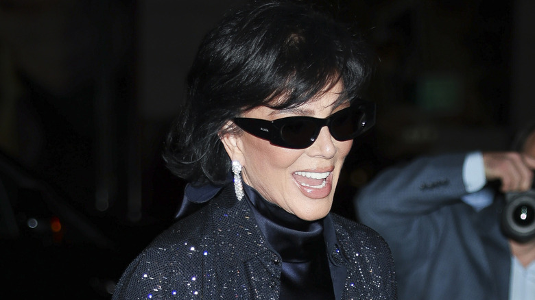 A smiling Kris Jenner wearing sunglasses