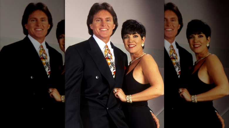 Caitlyn Jenner smiling alongside Kris Jenner, the latter of whom who's in a black dress