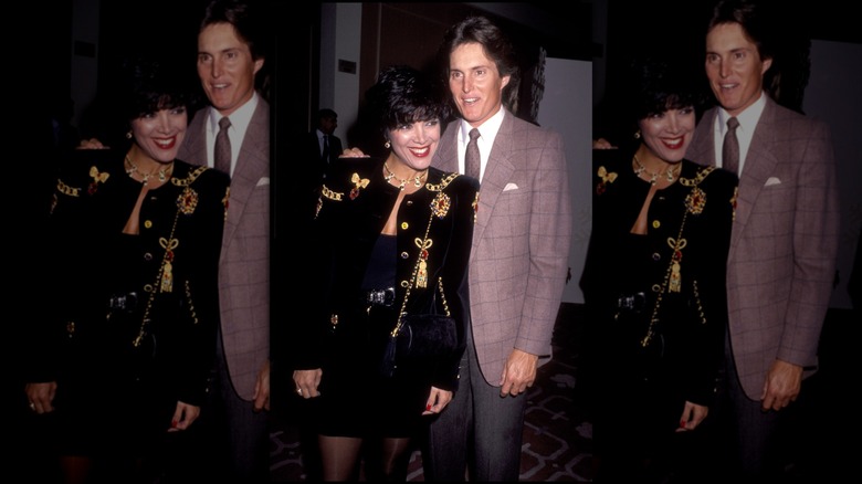Kris Jenner in a black embellished jacket over black tube top and matching skirt, smiling with Caitlyn Jenner