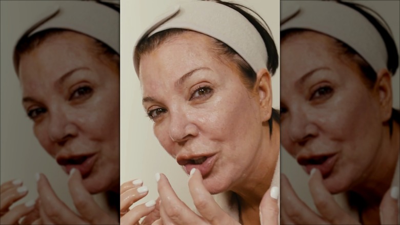 Kris Jenner speaking and wearing a wide headband.