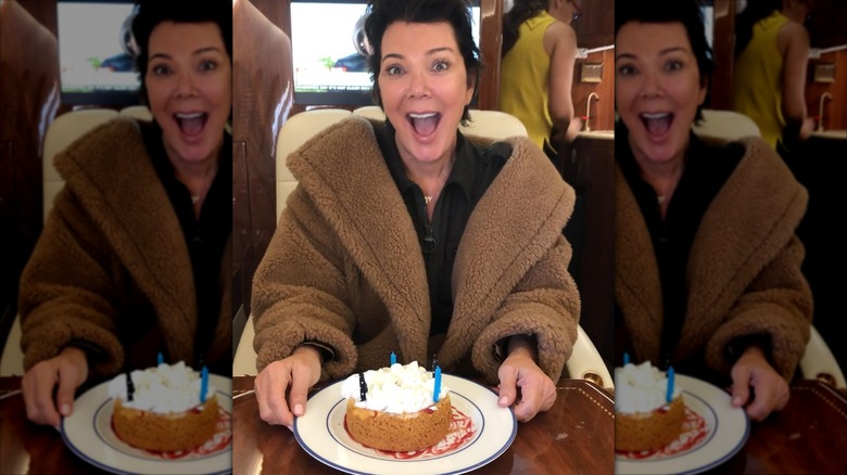 Kris Jenner smiling with cake.