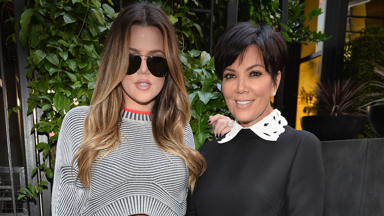 Khloé Kardashian and Kris Jenner posing at event