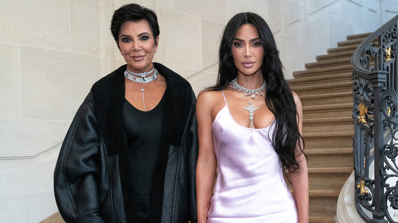 Kris Jenner and Kim Kardashian posing on a grand staircase