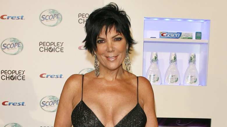 Kris Jenner smiling on step-and-repeat