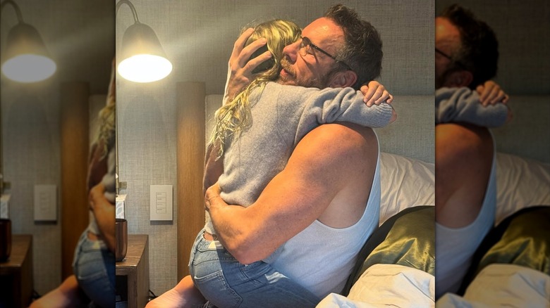 Dax Shepard embracing Kristen Bell while placing his hand on the back of her head.