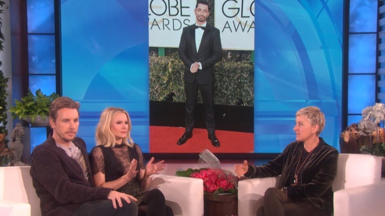 Kristen Bell and Dax Shepard talk to Ellen DeGeneres on her show with a photo of Riz Ahmed on the screen behind them.
