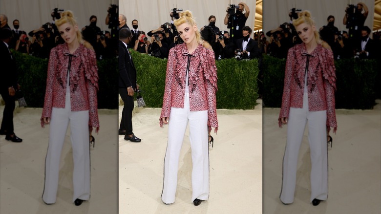 Kristen Stewart wearing a pink and white ensemble with retro bangs at the Met Gala.