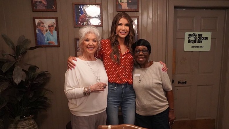 Paula Deen and Kristi Noem posing at the Lady & Sons restaurant