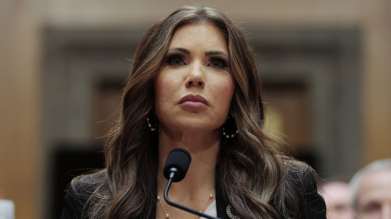Closeup of Kristi Noem at senate hearing with microphone in front of her