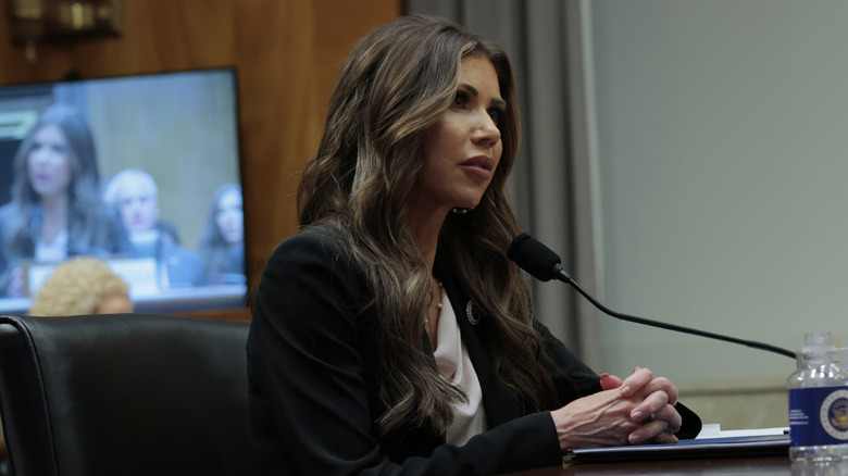 Kristi Noem speaking into mic at desk during senate hearing