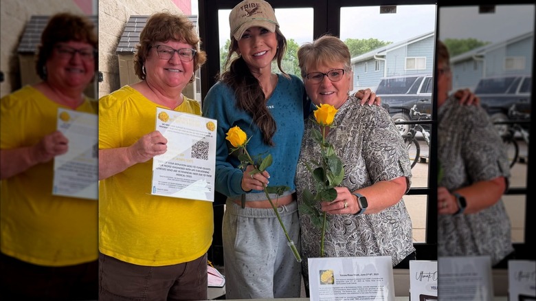 Kristi Noem standing between two women