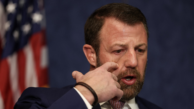 Markwayne Mullin touching his face