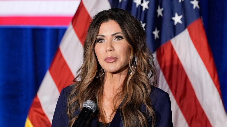 image of Kristi Noem in front of a microphone during a government event