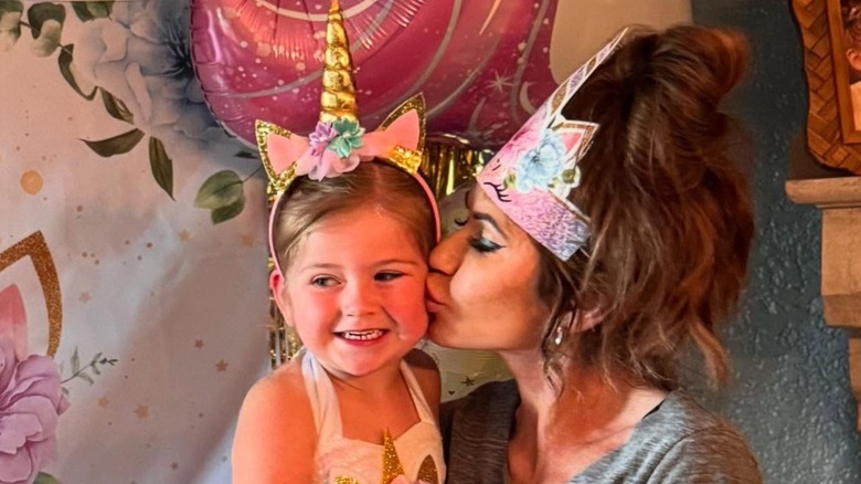 Kristi Noem kissing her granddaughter