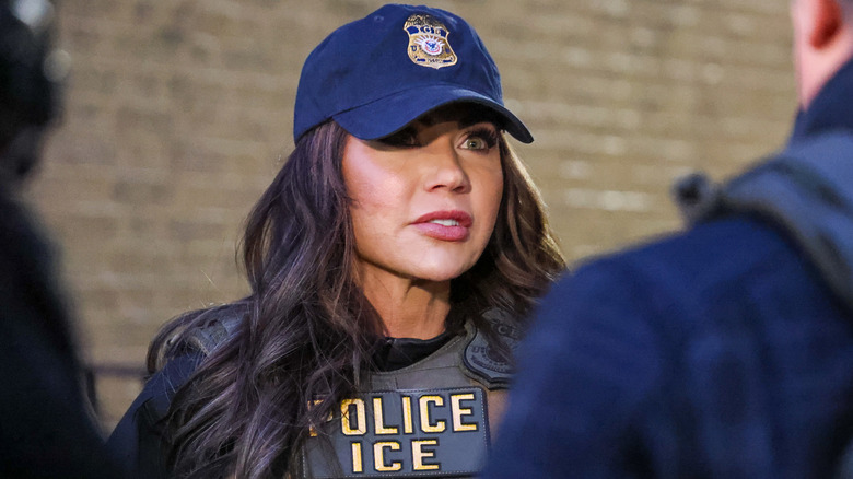 Kristi Noem wearing ICE vest and cap