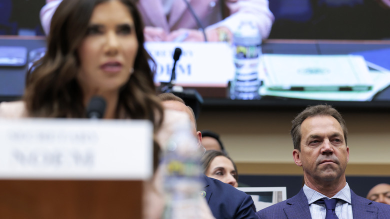 Bryon Noem sitting behind Kristi Noem