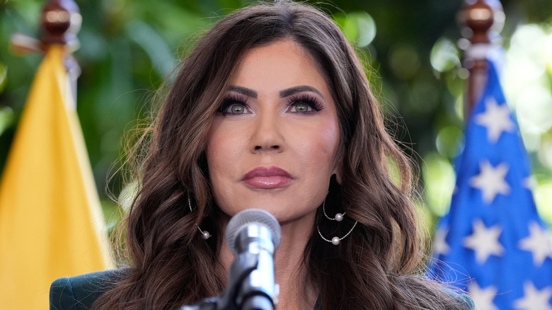 Kristi Noem outdoors at microphone
