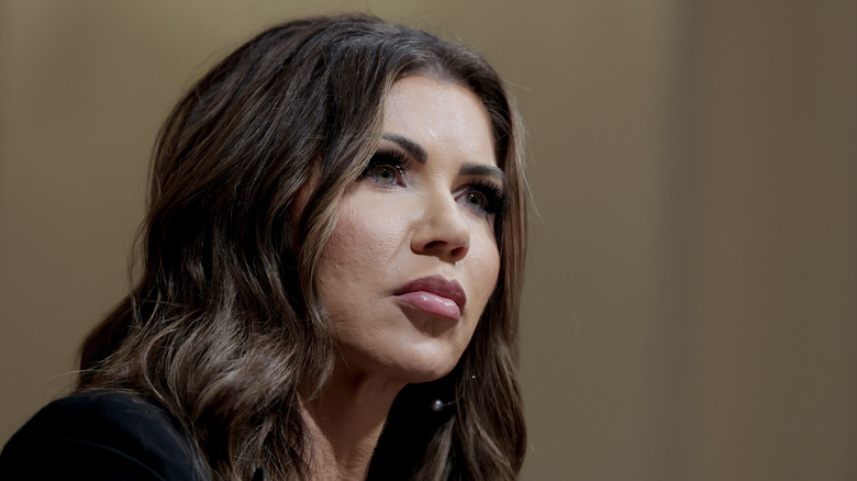 Kristi Noem at an event, looking off-camera with her hair down