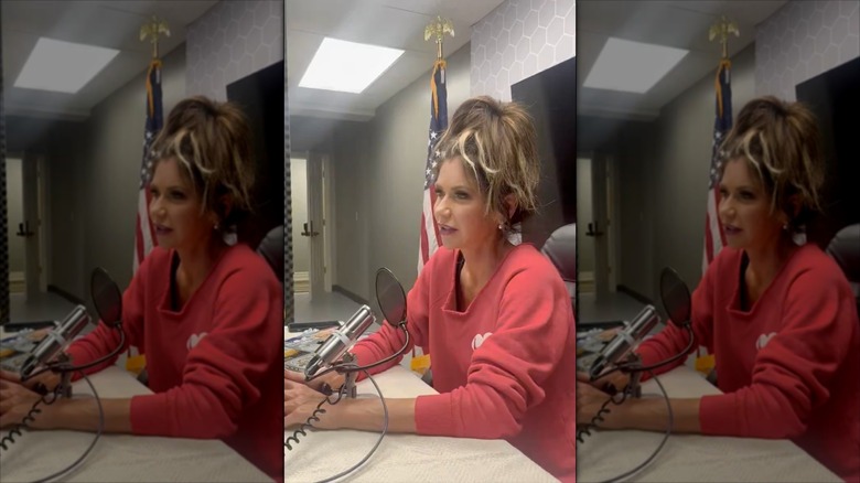 Kristi Noem speaks into a microphone