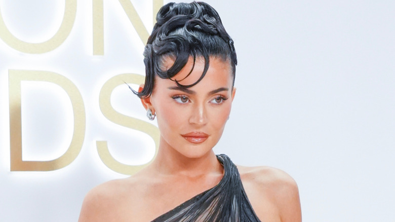 Kylie Jenner slicked back hair and black lace dress