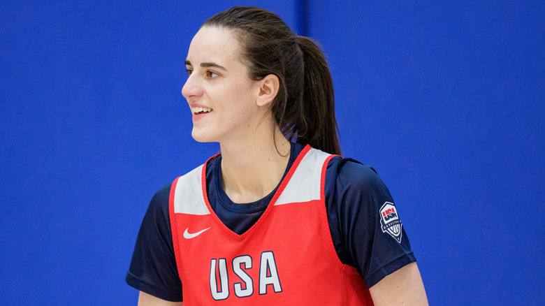 Caitlin Clark smiling on the basketball court