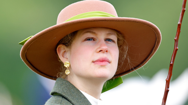 Lady Louise Windsor smiling wearing a hat and jacket.