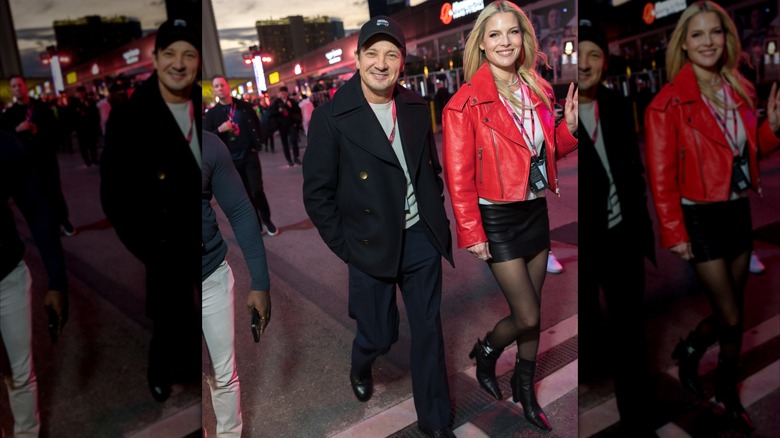 Jeremy Renner and Ali Larter wearing a black skirt, red leather jacket and white top
