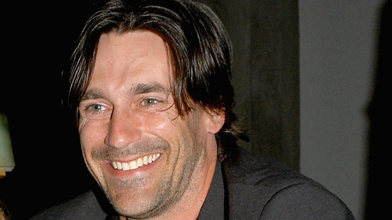 Smiling Jon Hamm with shaggy hair