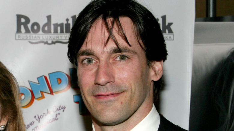 Smiling Jon Hamm posing for a photo in the early 2000s