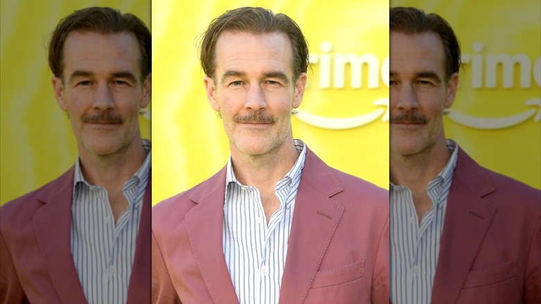 James Van Der Beek posing in a close-up wearing a red suit.