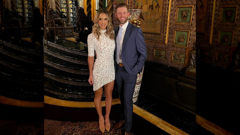 Lara Trump wearing a white minidress and posing with Eric Trump at Mar-a-Lago