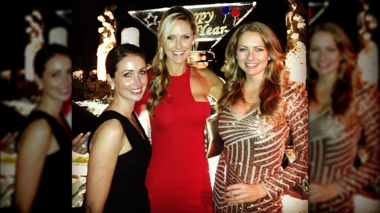 Lara Trump wearing a red dress and posing with friends at a New Year's Eve party