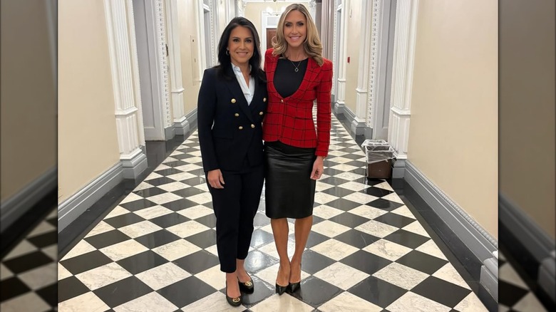 Lara Trump wearing red blazer and black skirt and posing with Tulsi Gabbard