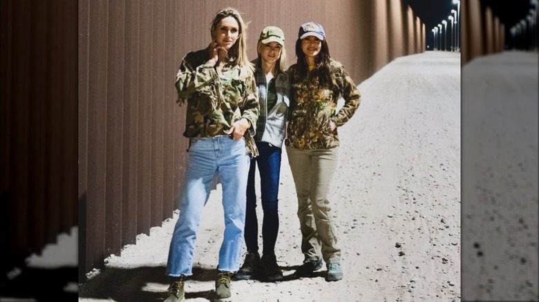 Lara Trump, Pam Bondi, and Morgan Ortagus posing in front of border wall