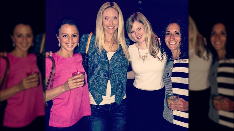 Lara Trump wearing a blue coat and posing with a group of friends