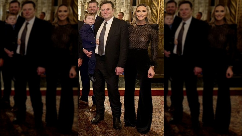 Lara Trump wearing a black jumpsuit with angular shoulders and posing beside Elon Musk