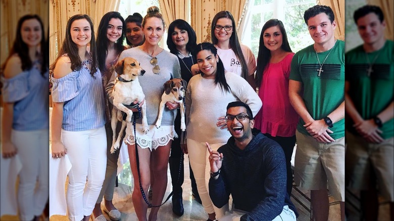 Lara Trump wearing white lace shorts and holding dogs in group photo