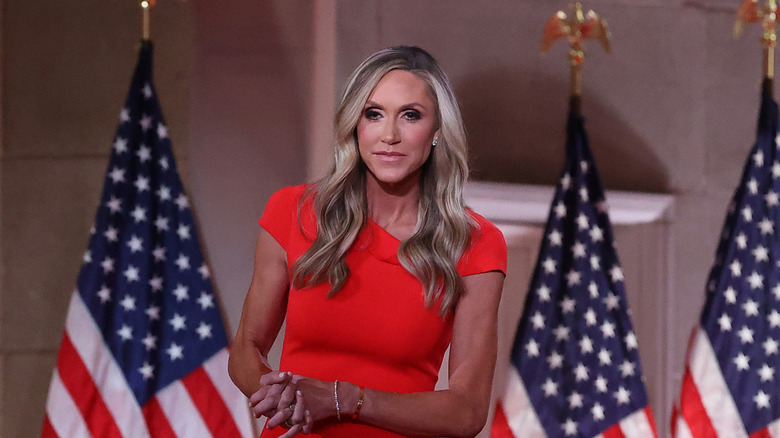 Lara Trump in a red dress in front of American flags