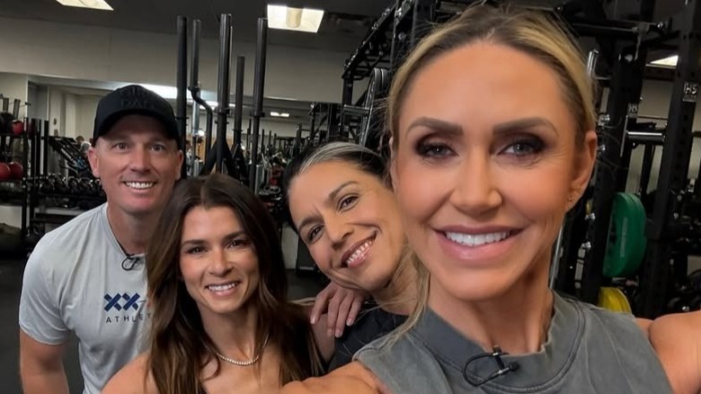 Dakota Meyer, Danica Patrick, and Lara Trump pose together in a gym in Fort Lesley J. McNair, Washington, DC (2025)