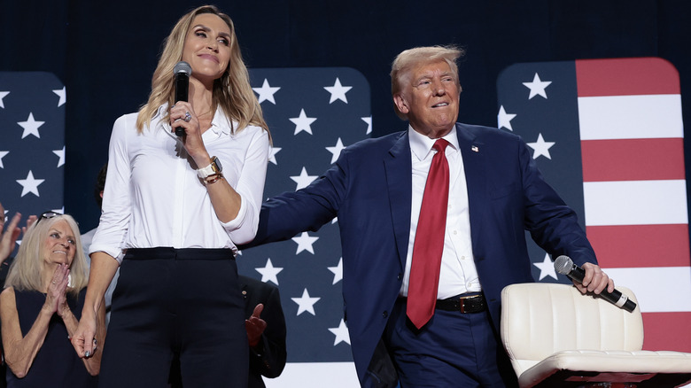 Donald Trump patting Lara Trump on the back