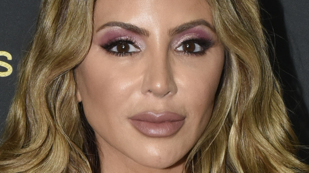 Larsa Pippen wears purple eye shadow and curly hair