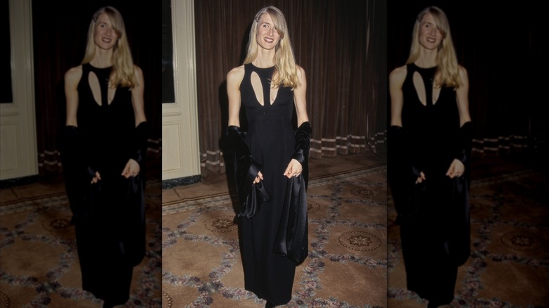 Laura Dern in a black dress and matching shawl, with two oval cut outs at the chest to emulate an almost V-neck effect.