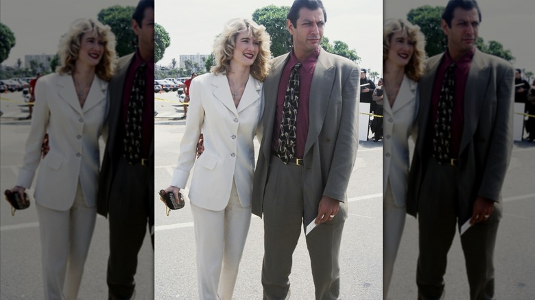 Laura Dern and Jeff Goldblum posing for pictures in suits