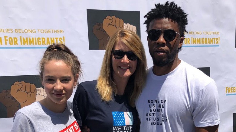Jaya Harper, Laura Dern, and Chadwick Boseman posing for a photo at a march