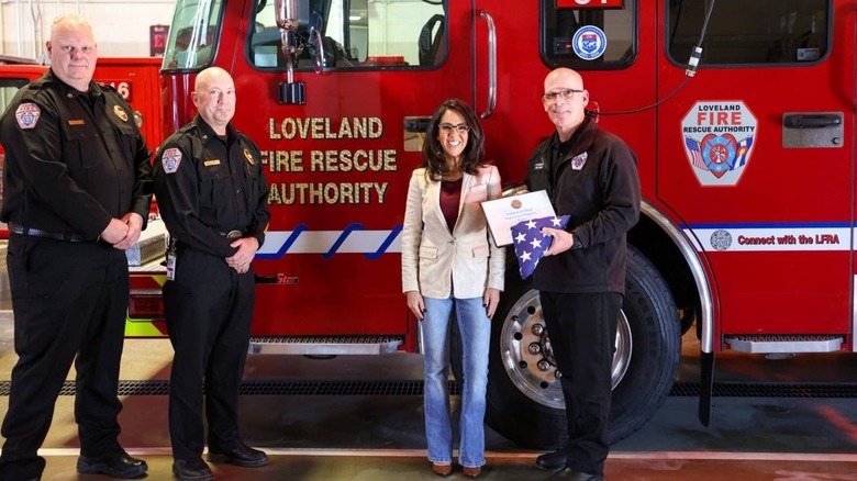 Lauren Boebert smiling with firefighters