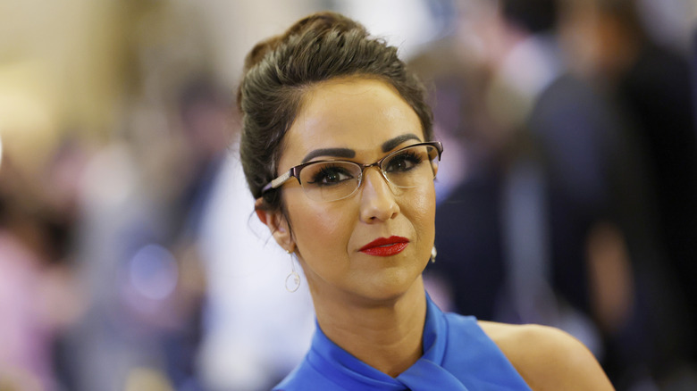 Lauren Boebert with an updo and red lipstick looking into camera