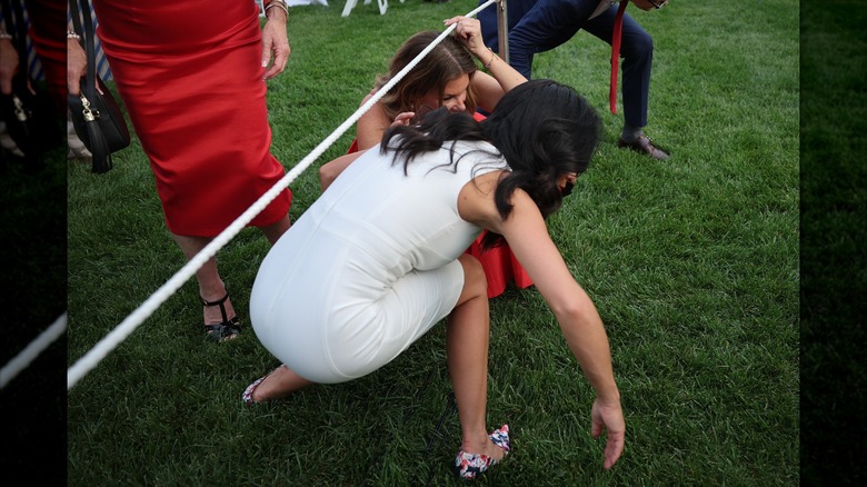 Lauren Boebert ducking under rope
