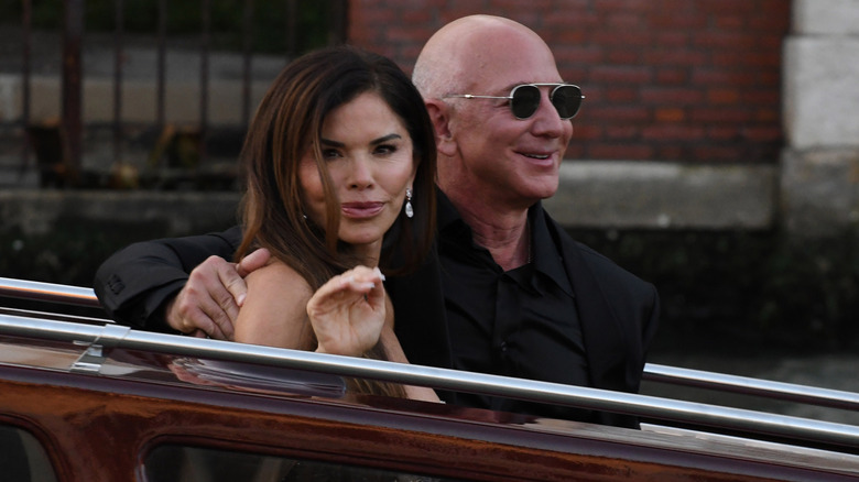 Jeff Bezos and Lauren Sanchez wave as they exit the Hotel Aman Wedding on June 28, 2025 in Venice, Italy (2025)