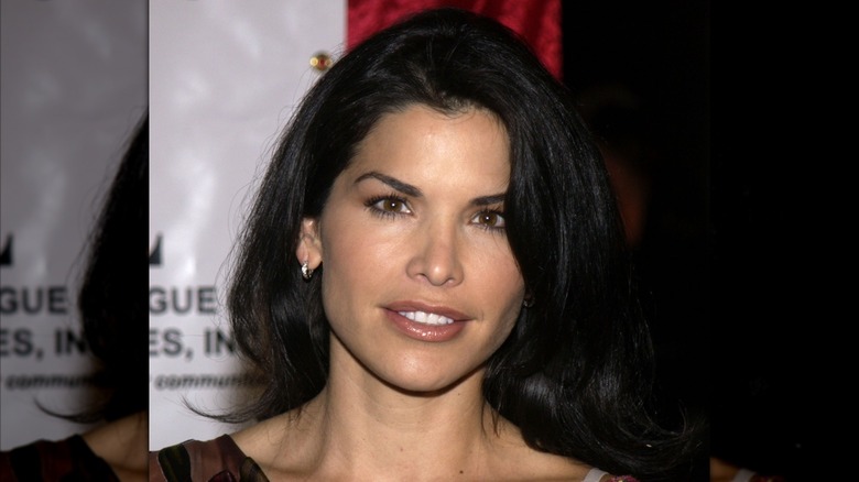 Lauren Sánchez posing on the red carpet with her long, side swept black hair