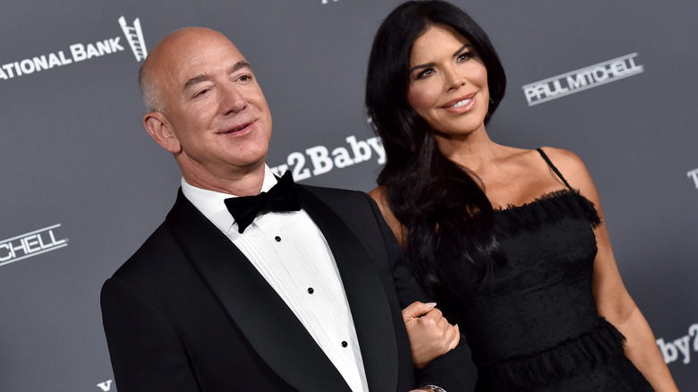 Jeff Bezos and Lauren Sanchez pose on the red carpet
